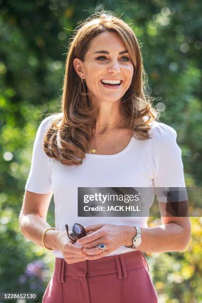 Britain's Catherine, Duchess of Cambridge, reacts as she meets with parents and children, and peer supporters, in Battersea Park, London on September...