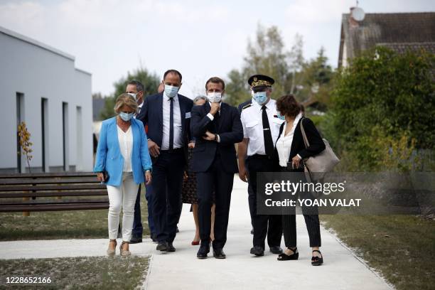 French President Emmanuel Macron , flanked by the director of the nursing home Pierre Gouabault , Loir-et-Cher Prefect Yves Rousset and French Junior...