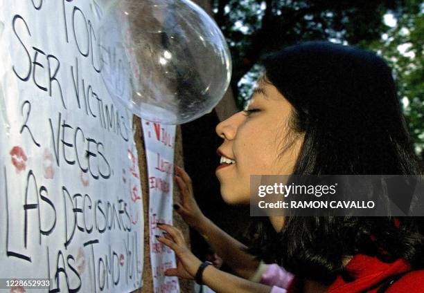 Young woman place posters remarks on the front of the house where president-elect Vicente Fox works in Mexico City, Mexico 16 August 2000. These...