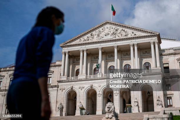 Woman walks in front of the Portuguese parliament in Lisbon on September 22, 2020.