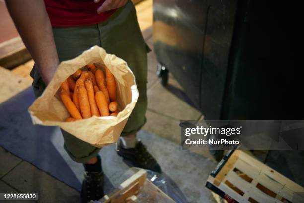 He just found 1kg of carrots. Tarin, a young man, searches for food in trash containers next to supermarkets. When needed he rides his bicycle in...