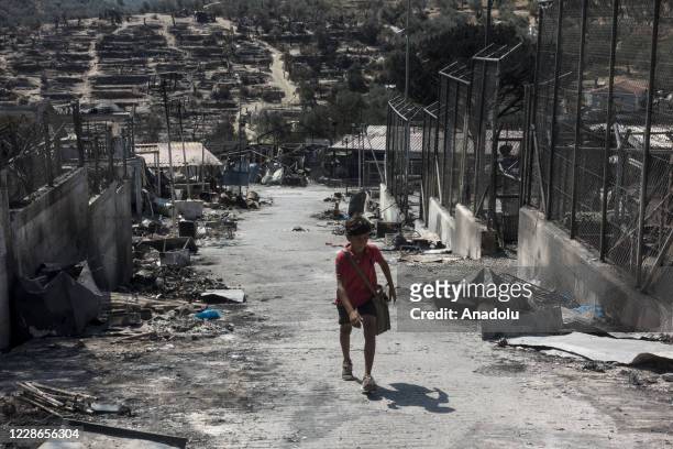 Group of refugees carry their belongings saved from the Moria refugee camp which became unuseable following fires that erupted on September 9, in the...
