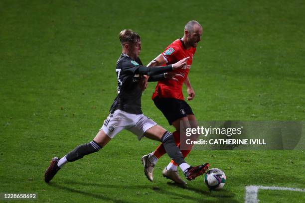 Vies with Luton Town's English striker Danny Hylton Manchester United's English defender Brandon Williams during the English League Cup third round...