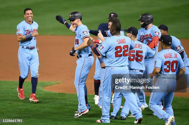 The Minnesota Twins congratulates Max Kepler on a walk-off single against the Detroit Tigers during the tenth inning of the game at Target Field on...