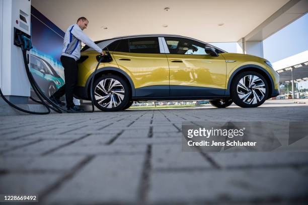 Worker charges the new Volkswagen ID.4 electric sport utility vehicle at the VW factory on September 18, 2020 in Zwickau, Germany. Volkswagen will...