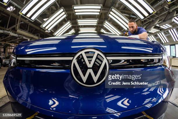 Workers assemble the new Volkswagen ID.4 electric sport utility vehicle at the VW factory on September 18, 2020 in Zwickau, Germany. Volkswagen will...