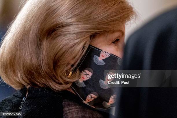 Supreme Court reporter Nina Totenberg wears a face mask with depictions of Justice Ruth Bader Ginsburg on it during a private ceremony for Justice...