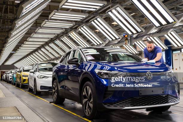 Workers assemble the new Volkswagen ID.4 electric sport utility vehicle at the VW factory on September 18, 2020 in Zwickau, Germany. Volkswagen will...
