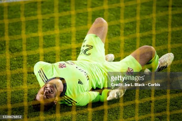 Goalkeeper Alex Bono of Toronto FC lies on the ground holding his back and screaming in pain after a hit by Valentin Castellanos of New York City in...