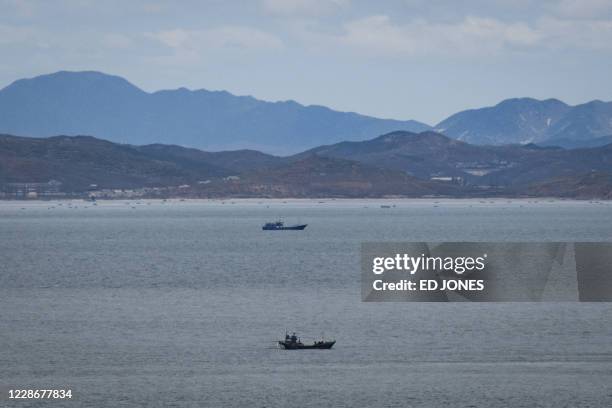 This photo taken on April 24, 2018 shows a general view of unidentified fishing boats before the North Korean coastline from a viewpoint on the South...