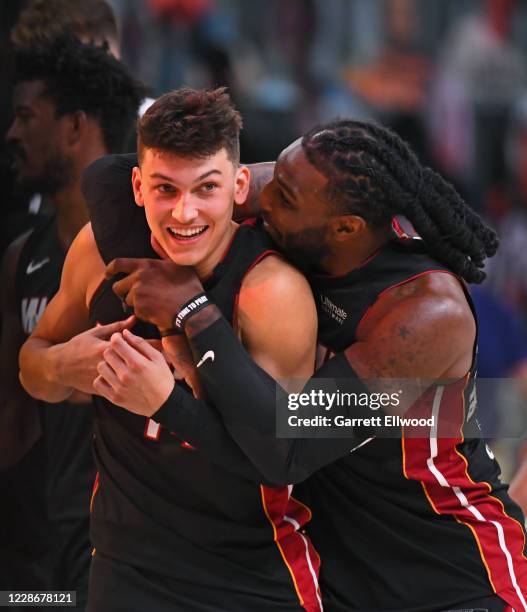 Jae Crowder and Tyler Herro of the Miami Heat smile and celebrate on the court after Game Four of the Eastern Conference Finals against the Boston...