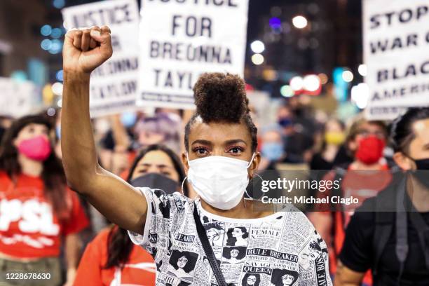 Sheree Barbour holds her fist in the air as people protest the grand jury decision in the Breonna Taylor case on September 23, 2020 in Denver, United...