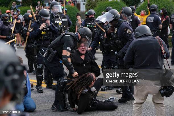 Protestors are detained by police as they march in downtown Louisville, Kentucky, on September 23 after a judge announced the charges brought by a...