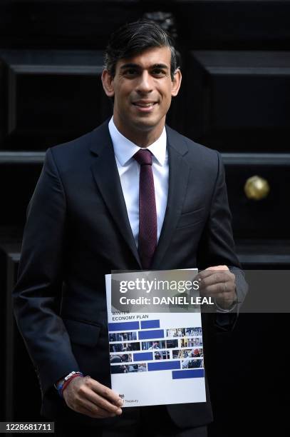 Britain's Chancellor of the Exchequer Rishi Sunak poses with his 'Winter Economy Plan' outside 11 Downing street in central London on September 24,...