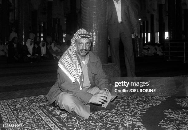 Palestinian leader Yasser Arafat prays in the mosque of Conakry, Guinea, during the funeral ceremony of Guinean president Ahmed Sekou Toure, 30 March...