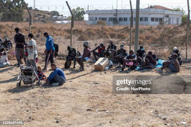 The New Temporary Refugee Camp in Kara Tepe - Mavrovouni with large white tents having the UNHCR or UNICEF logo and asylum seekers waiting in line...