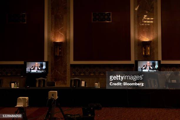 Elliott Abrams, special representative for Iran and Venezuela at the U.S. Department of State, is displayed on screens during a Senate Foreign...