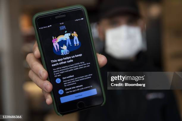 Smartphone displays a screen from the newly released 'NHS COVID-19' contract tracing app in this arranged photograph in London, U.K., on Thursday,...