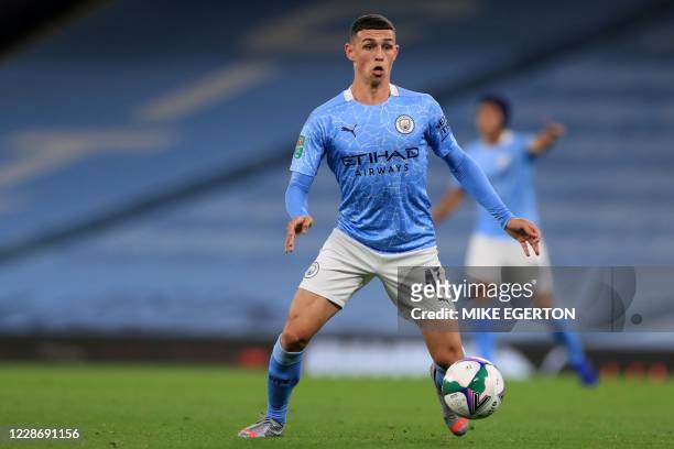 Manchester City's English midfielder Phil Foden looks to play a pass during the English League Cup third round football match between Manchester City...