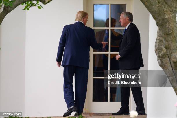 President Donald Trump, left, and Mark Meadows, White House chief of staff, exit the Oval Office of the White House before boarding Marine One in...