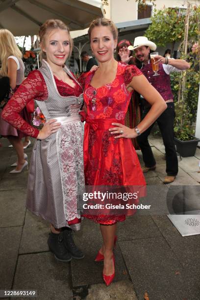Johanna Mross and her mother Stefanie Hertel an Lanny Lanner making fun in the background during the Ladies Red Wiesn 2020 at Rabenwirt on September...