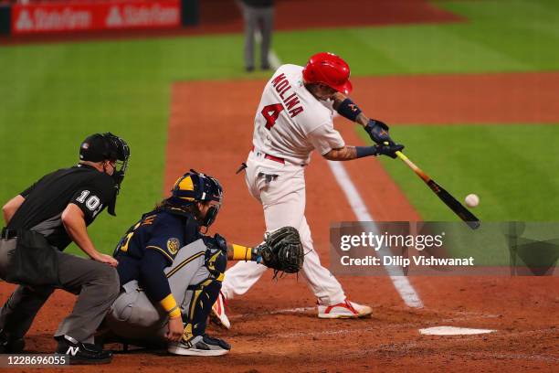 Yadier Molina of the St. Louis Cardinals records his 2,000th career hit with a single against the Milwaukee Brewers in the seventh inning at Busch...