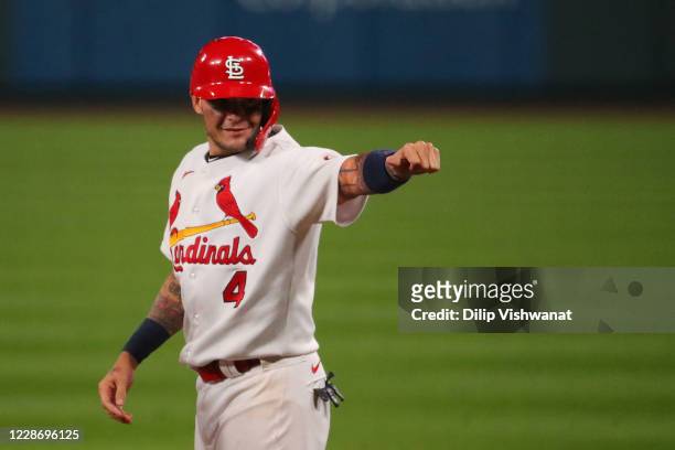Yadier Molina of the St. Louis Cardinals acknowledges his teammates in the dugout after recording his 2,000th career hit with a single against the...
