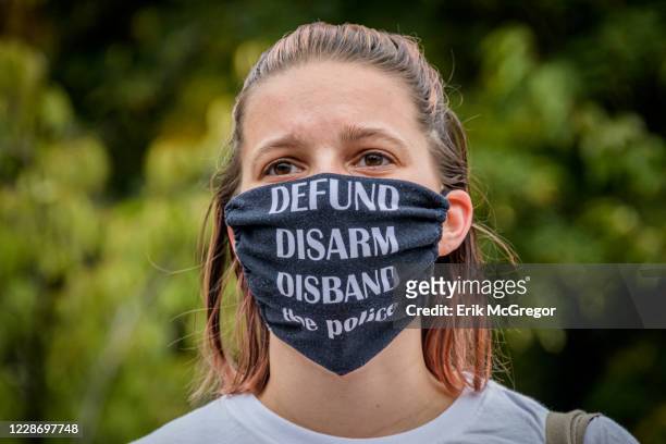 Participant wearing a Defund The Police face mask at the protest. Brooklynites gathered at Maria Hernandez Park in Bushwick to demand justice for...