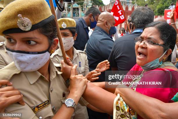 Police personnel detain an activist from a farmers rights organisation during a protest following the recent passing of agriculture bills in the Lok...