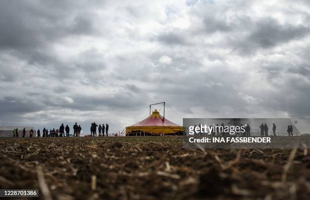 European climate activists stand at their camp on September 25, 2020 in near Juechen, western Germany, during the days of their mass action aiming to...