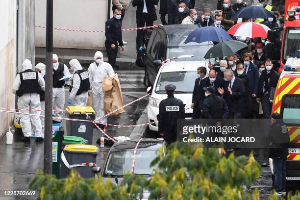 French Prime Minister Jean Castex and French Interior Minister Gerald Darmanin arrive at the scene where several people were injured near the former...