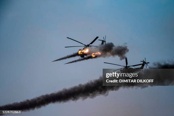 Russian attack helicopters launch rockets during military exercises at the Kapustin Yar range in Astrakhan region, Southern Russia on September 25,...