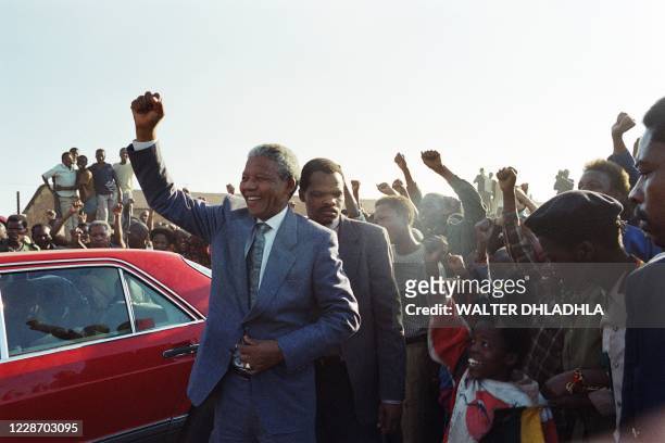 President Nelson Mandela with the raised fist greet supporters in Boipatong on July 9, 1991 where members of an ANC delegate's family were murdered a...