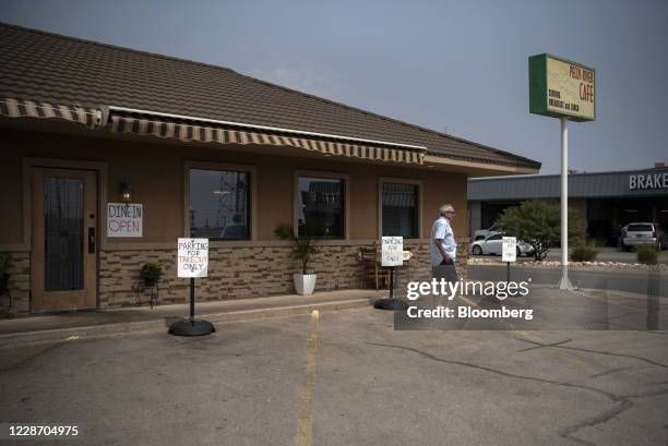 Customer leaves Pecos River Cafe in Carlsbad, New Mexico, U.S., on Friday, Sept. 11, 2020. With the U.S. Oil industry reeling from the collapse in...