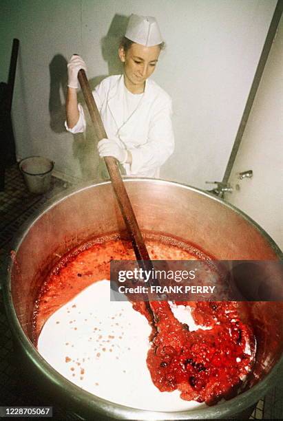 Une employée de "La Fraiseraie" de Pornic mélange, le 04 août, sucre et fraises pour fabriquer de la confiture. "La Fraiseraie", entreprise...