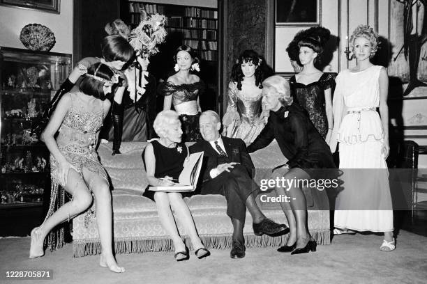 French writer and journalist Gisèle d'Assailly presents her book "Les Quinze Révolutions de la mode" to French singer Maurice Chevalier, on November...