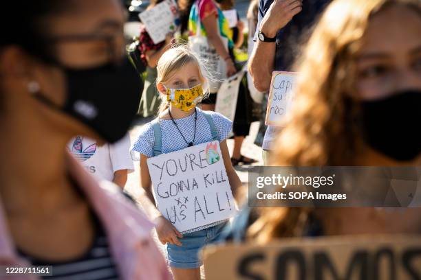 Young protester holding a placard expressing her opinion during the climate strike. Portuguese students joined the international movement Fridays for...