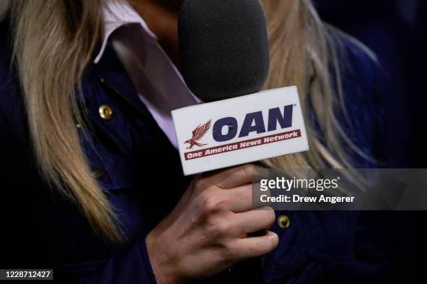 Reporter with One America News Network works at a campaign rally with President Donald Trump at Newport News/Williamsburg International Airport on...