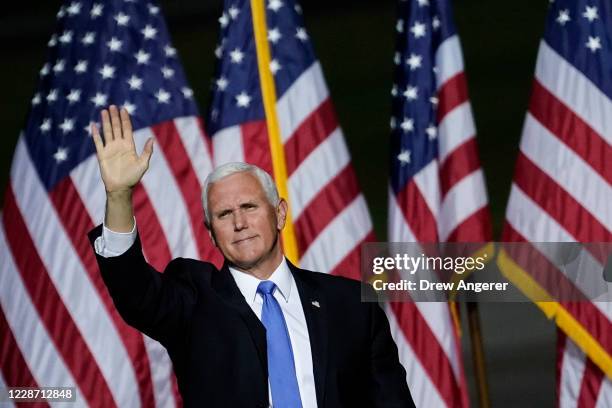 Vice President Mike Pence waves after speaking during a campaign rally at Newport News/Williamsburg International Airport on September 25, 2020 in...
