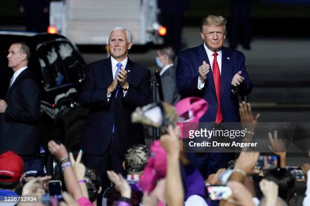 President Donald Trump and Vice President Mike Pence arrive for a campaign rally at Newport News/Williamsburg International Airport on September 25,...