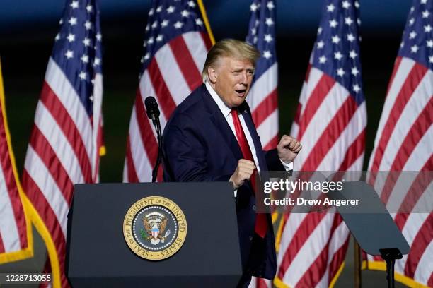 President Donald Trump dances to the song "YMCA" at the end of a campaign rally at Newport News/Williamsburg International Airport on September 25,...