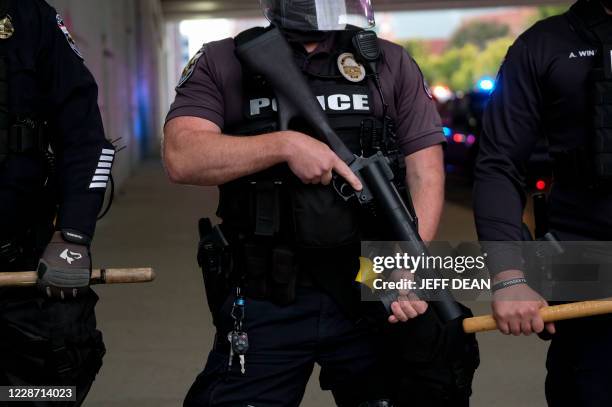 Police officers in riot gear form a line in the bourbon district, on a third day of protest over the lack of criminal charges in the police killing...