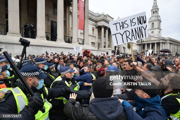 Police move in to disperse protesters in Trafalgar Square in London on September 26 at a 'We Do Not Consent!' mass rally against vaccination and...