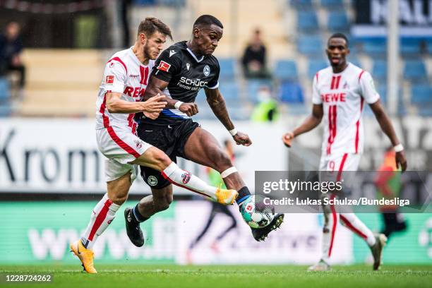 Jan Thielmann of Köln and Sergio Cordova of Bielefeld in action during the Bundesliga match between DSC Arminia Bielefeld and 1. FC Köln at Schueco...