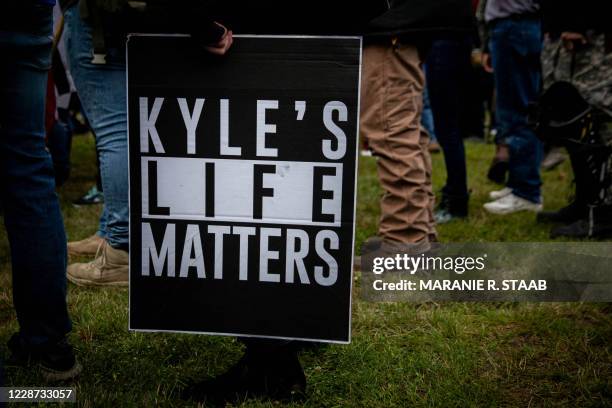 Person holds a sign that reads "Kyle's Life Matters", a reference to Kyle Rittenhouse, as several hundred members of the Proud Boys and other similar...