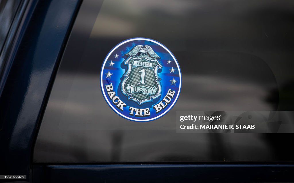 For Demonstration Only Sticker A sticker supporting law enforcement is seen as several hundred... News ...