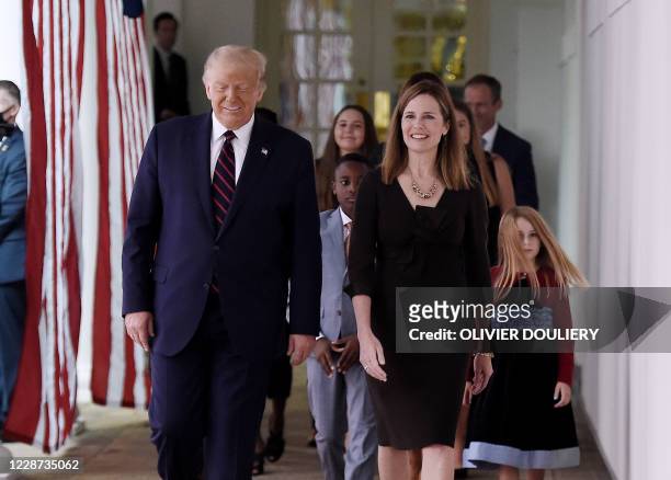 President Donald Trump and Judge Amy Coney Barrett , arrive at the Rose Garden of the White House in Washington, DC, on September 26, 2020. - Judge...