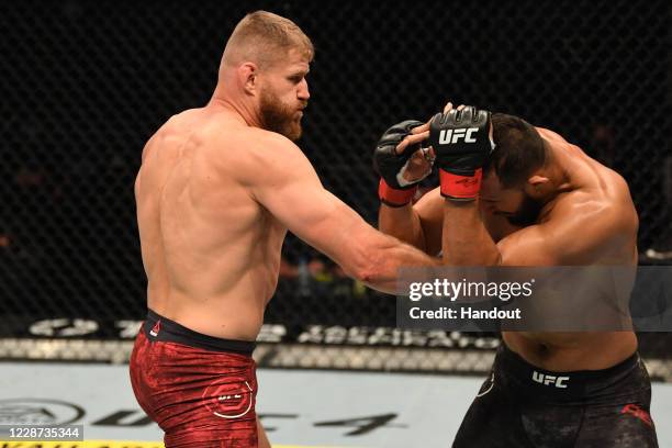 Jan Blachowicz of Poland punches Dominick Reyes in their light heavyweight championship bout during UFC 253 inside Flash Forum on UFC Fight Island on...