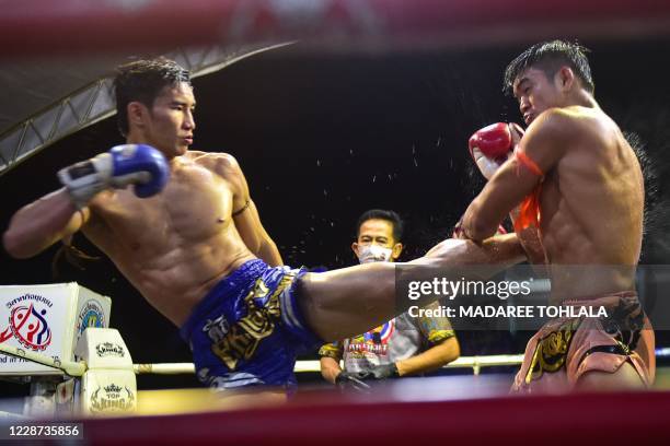 This picture taken on September 26, 2020 shows Muay Thai fighters competing in a match in Rueso district in Thailand's southern province of...
