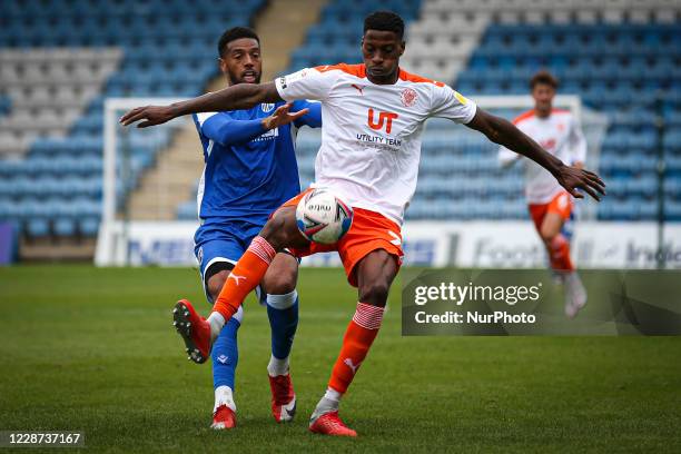 Vadaine Oliver of Gillingham battles for possession with Marvin Ekpiteta of Blackpool during the Sky Bet League 1 match between Gillingham and...